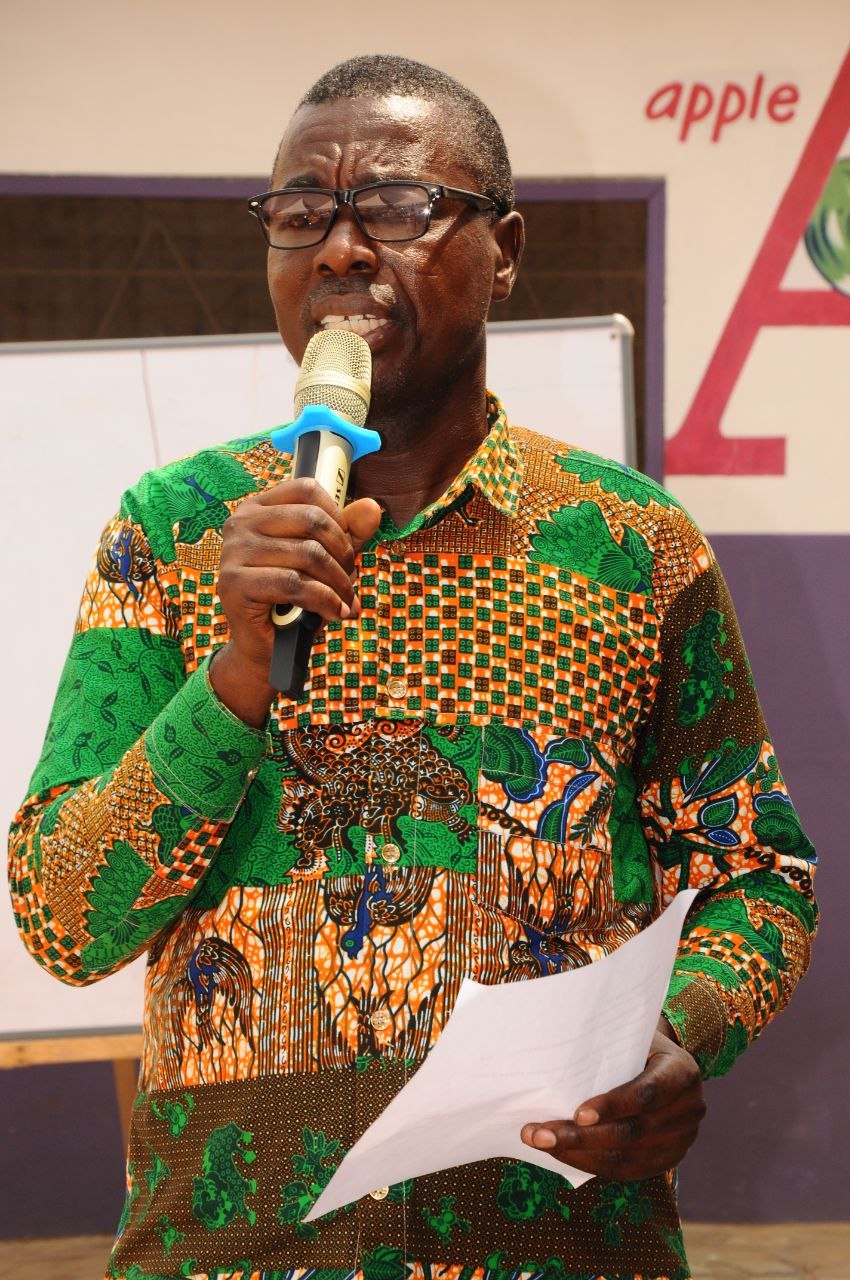 Student speaking into a microphone during a creative presentation